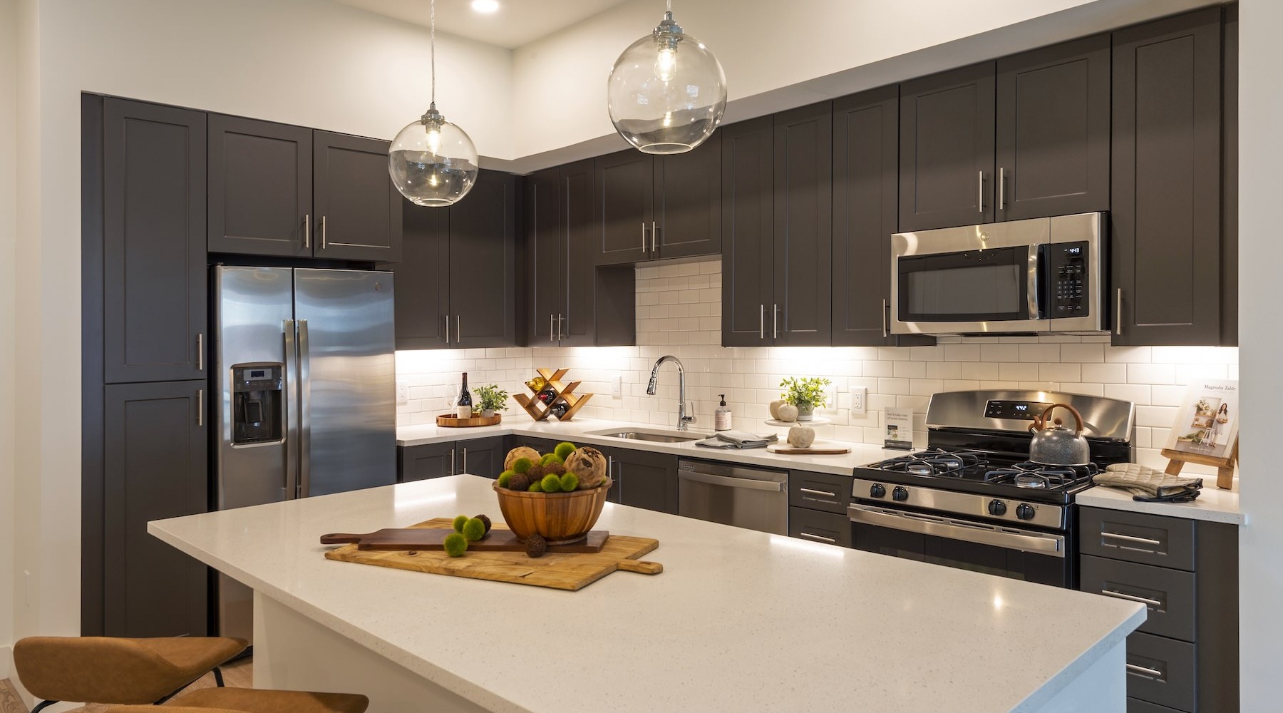a well-lit kitchen with white countertops